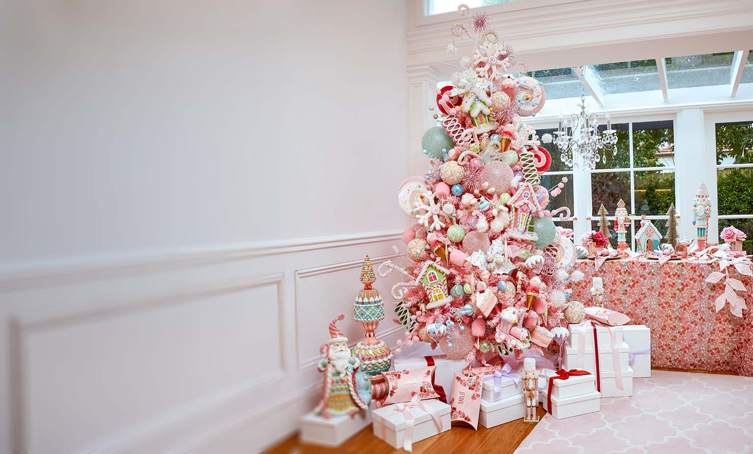 Beautiful pastel Christmas tree with luxury ornaments, Christmas garlands, and gifts styled by Christmas Decorators Sydney.
