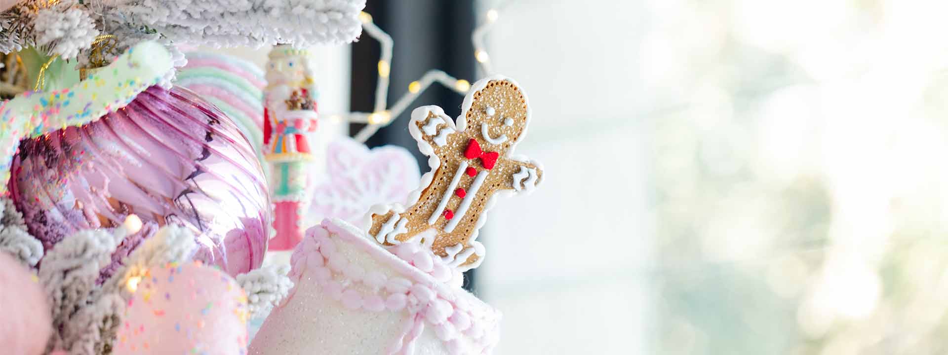 Close-up of gingerbread cookie and pastel ornaments, luxury christmas trees from exclusive christmas ornament packages and unique christmas trees.