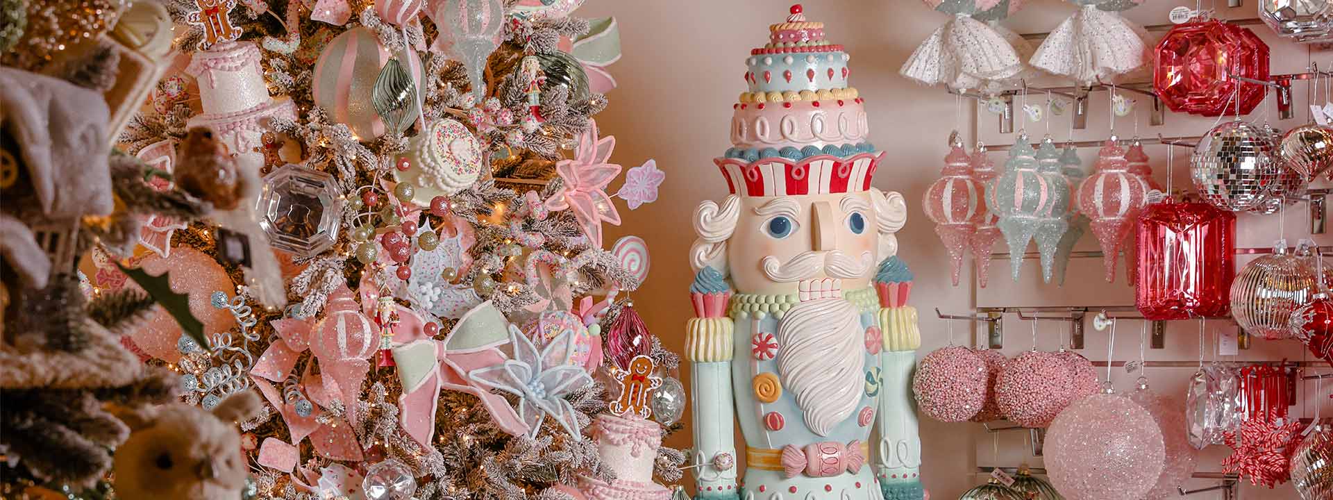 Whimsical Christmas tree with pastel ornaments, nutcracker, and Christmas garlands by Dancer and Dasher.