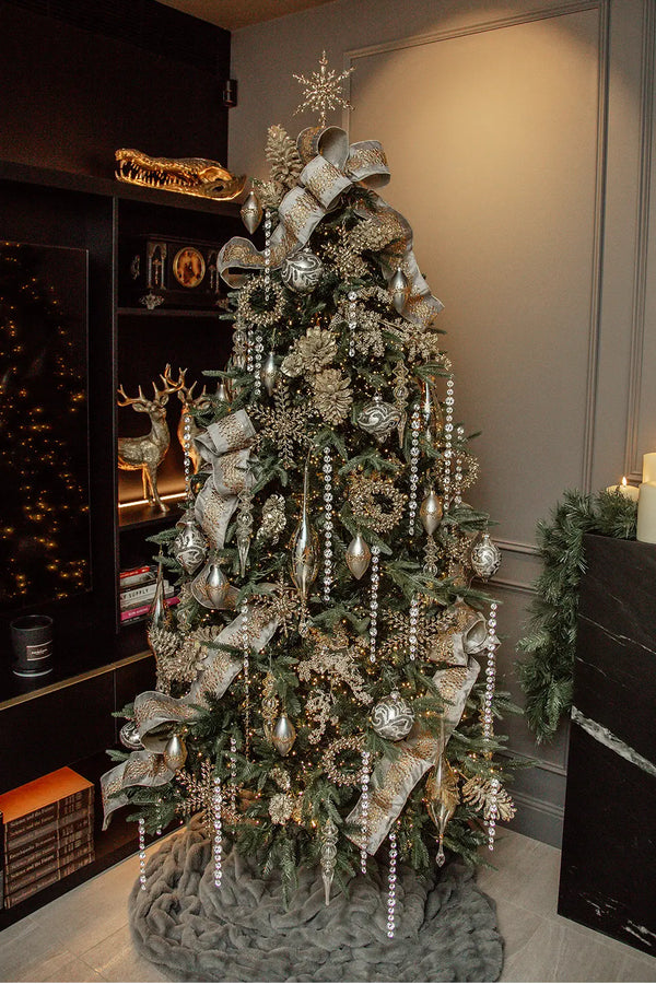  A beautifully decorated Christmas tree in an indoor setting, adorned with shimmering ornaments