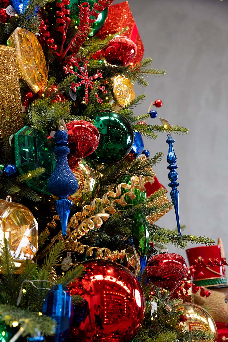 Christmas tree dressed with blue finial ornaments, gold garland and green baubles from the Dancer & Dasher range
