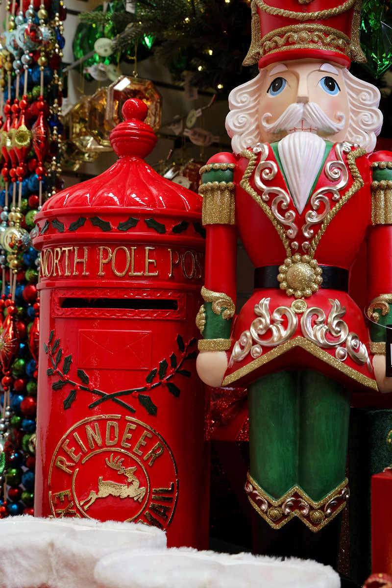 Giant red and gold nutcracker beside a North Pole post box, part of the luxury Christmas decor at Dancer & Dasher