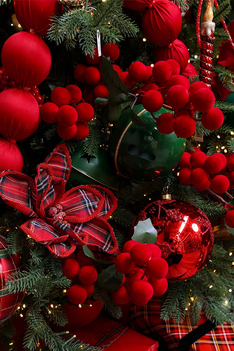 Close-up of red berries, tartan ribbon and glossy red baubles, Christmas tree decorations available in Sydney